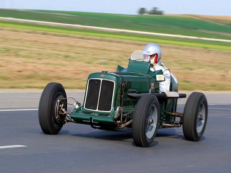 Vintage green race car on track