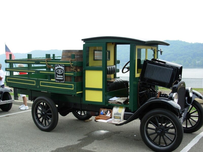 vintage green truck with whiskey barrel
