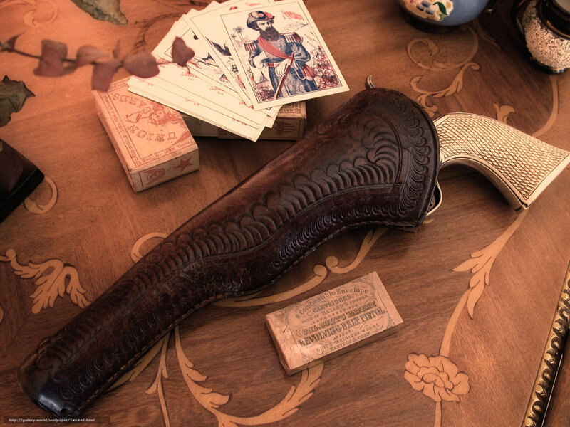Vintage gun and cards on table