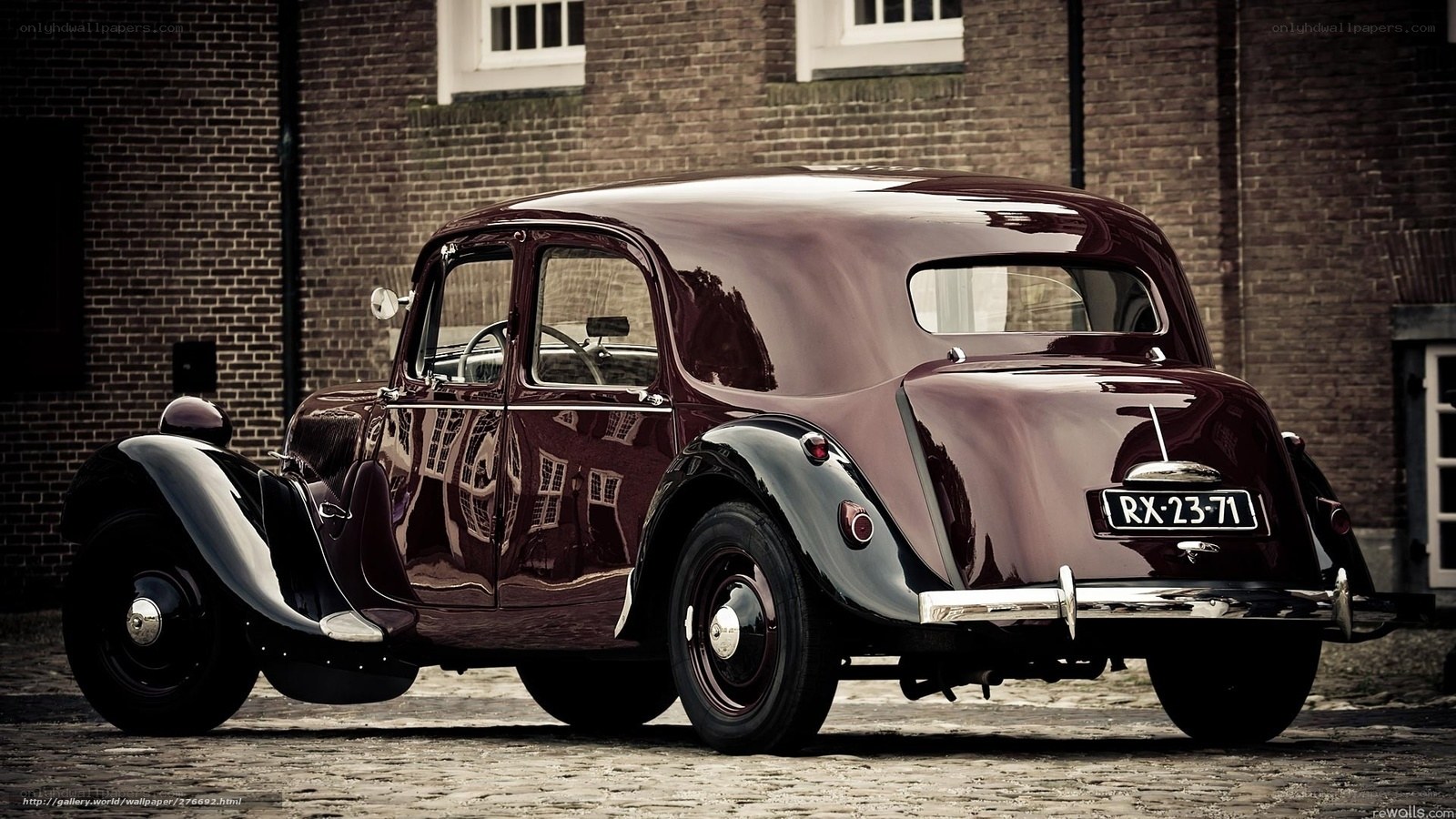vintage maroon car on cobblestone
