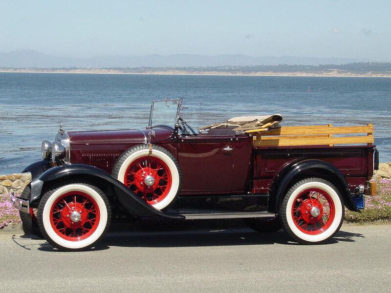 Vintage maroon pickup by the sea