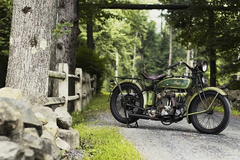 vintage motorcycle on a forest path