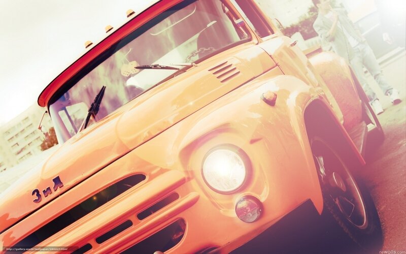 vintage orange truck at car show