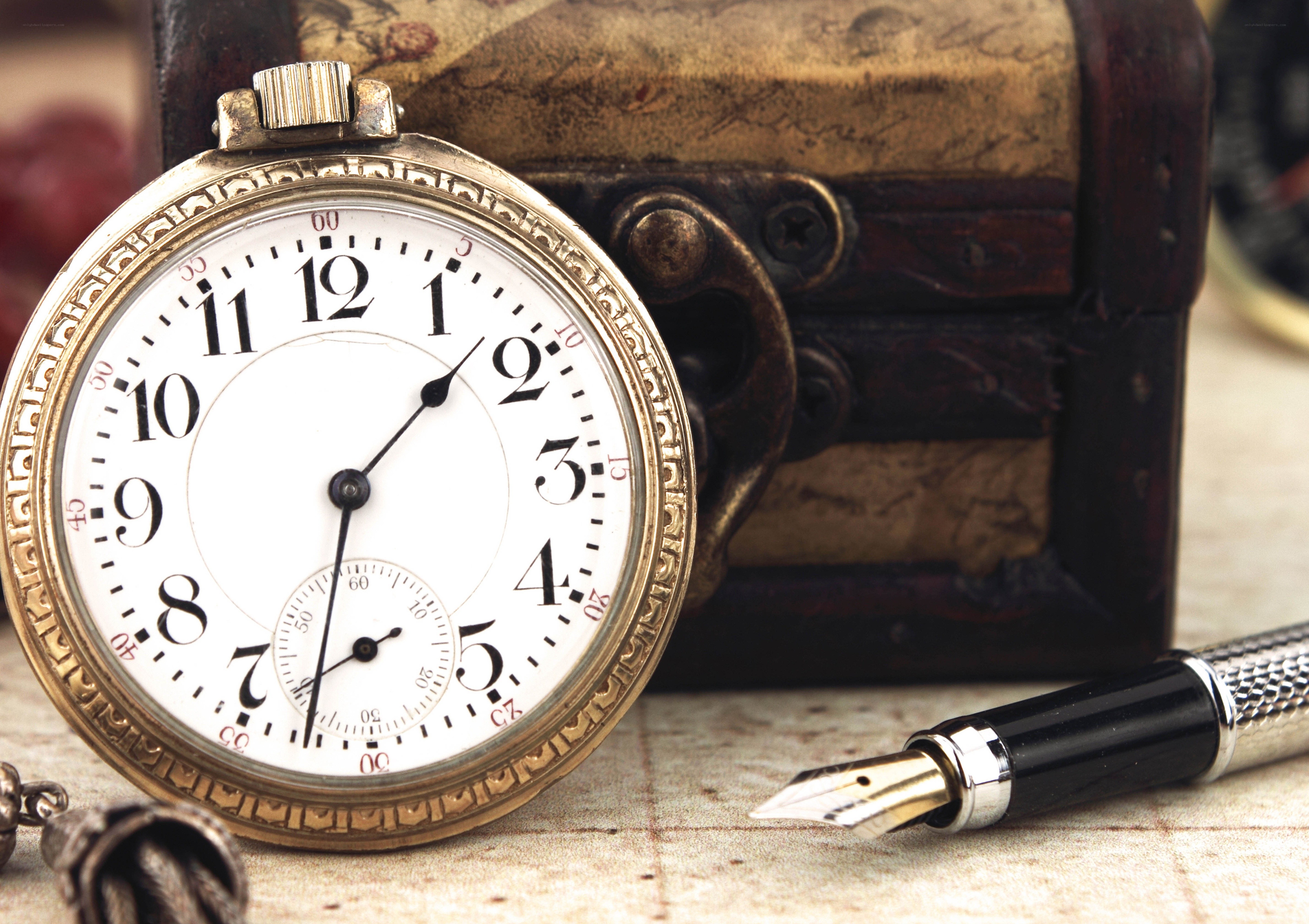 vintage pocket watch and pen