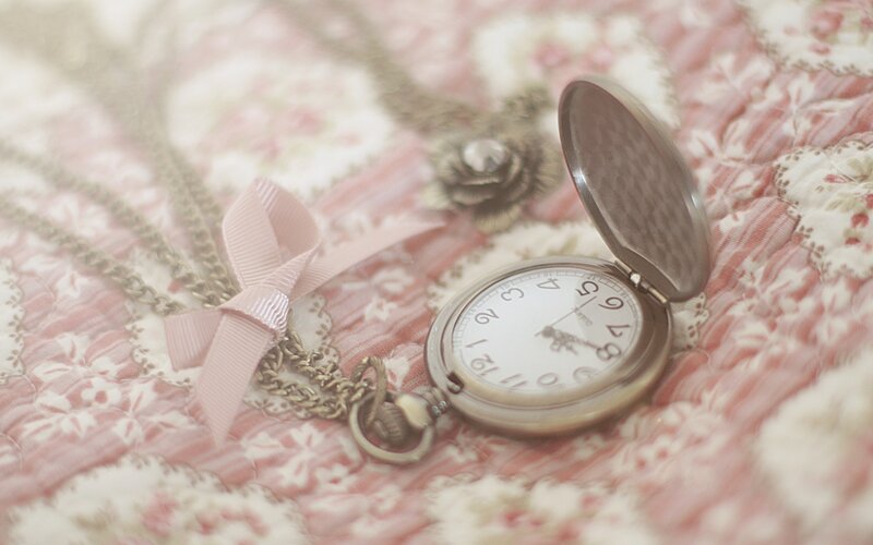 Vintage pocket watch on floral fabric
