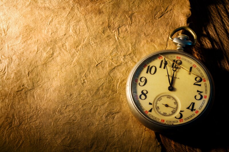 vintage pocket watch on textured paper