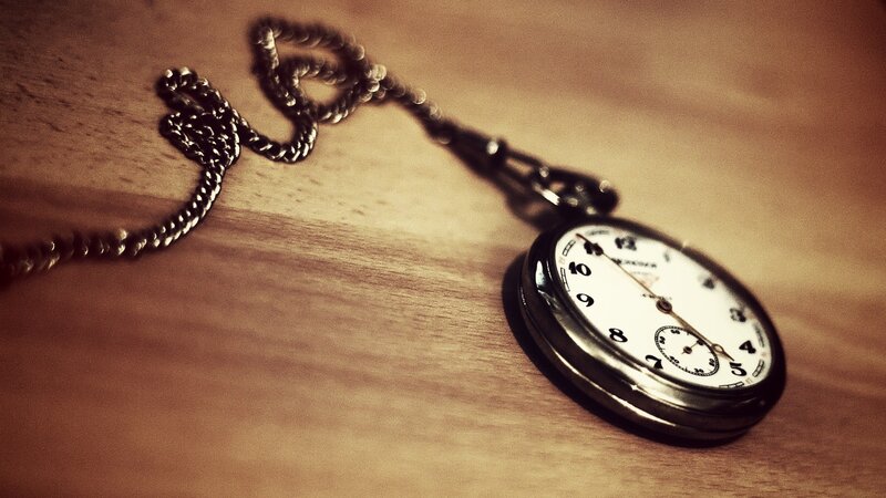 vintage pocket watch on wood
