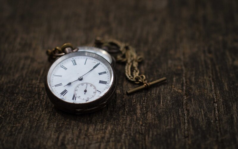 vintage pocket watch on wood