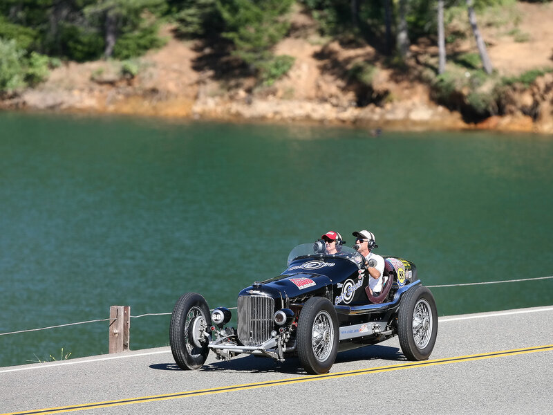 Vintage race car on coastal road