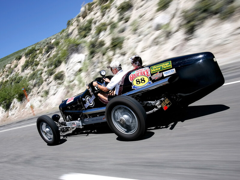 Vintage race car on mountain road