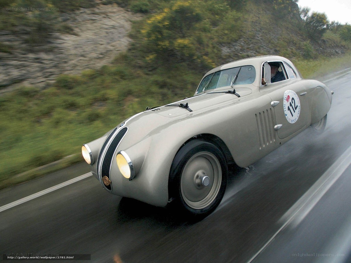 vintage race car on wet road