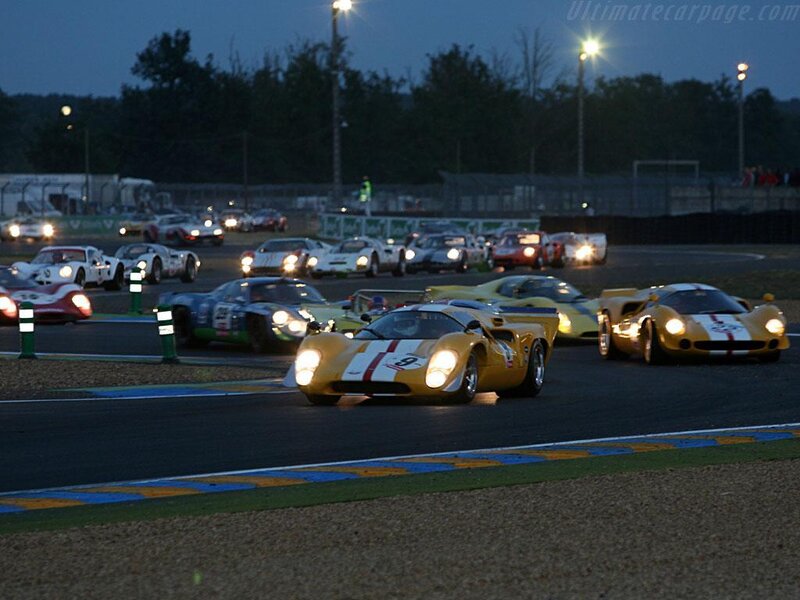Vintage race cars at dusk
