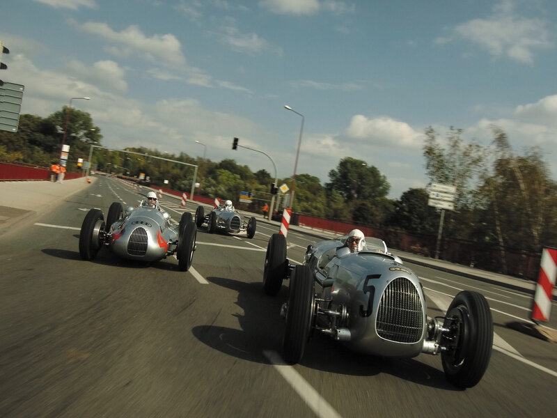 Vintage race cars on a road