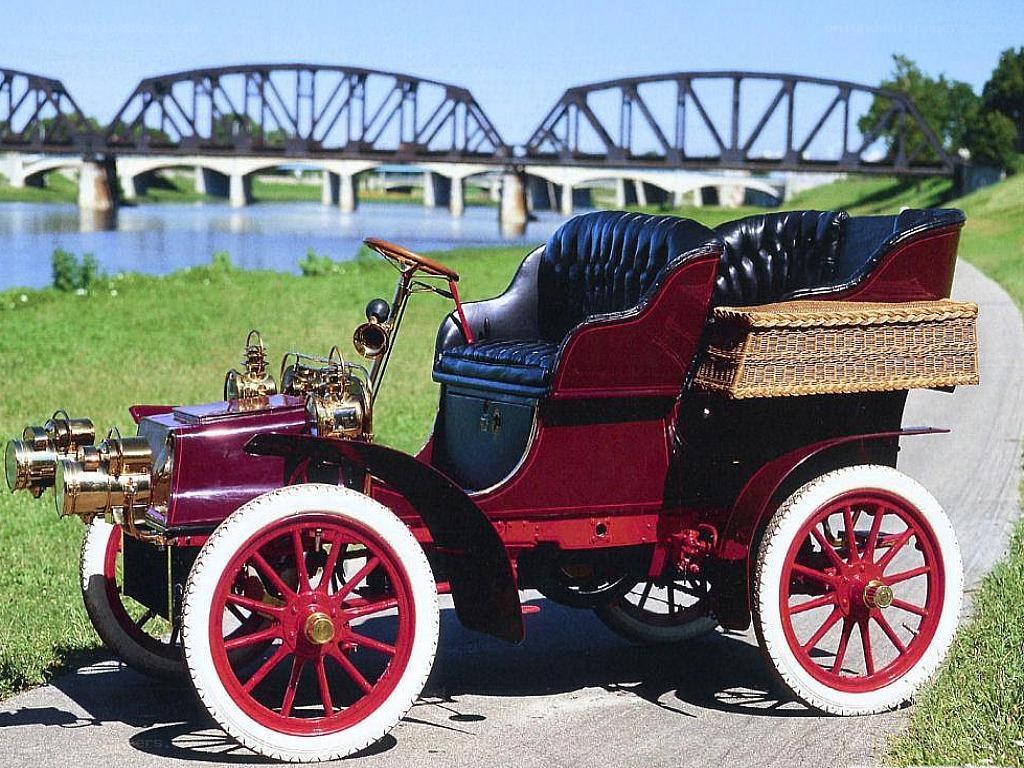 Vintage red automobile by river