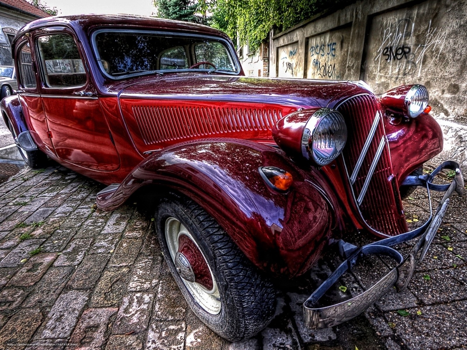 vintage red car on cobblestones