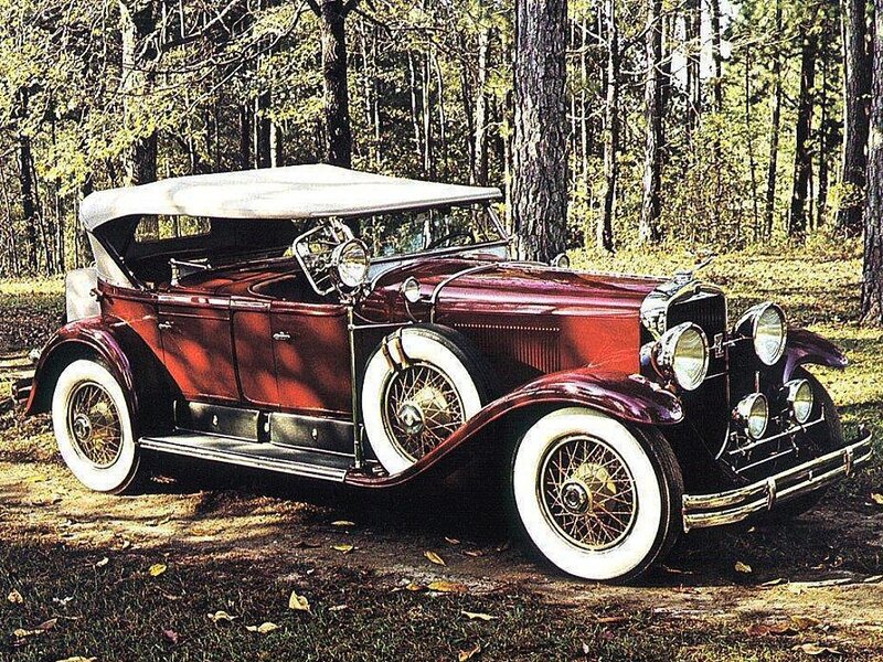 Vintage red convertible in forest