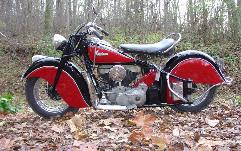 vintage red motorcycle in forest