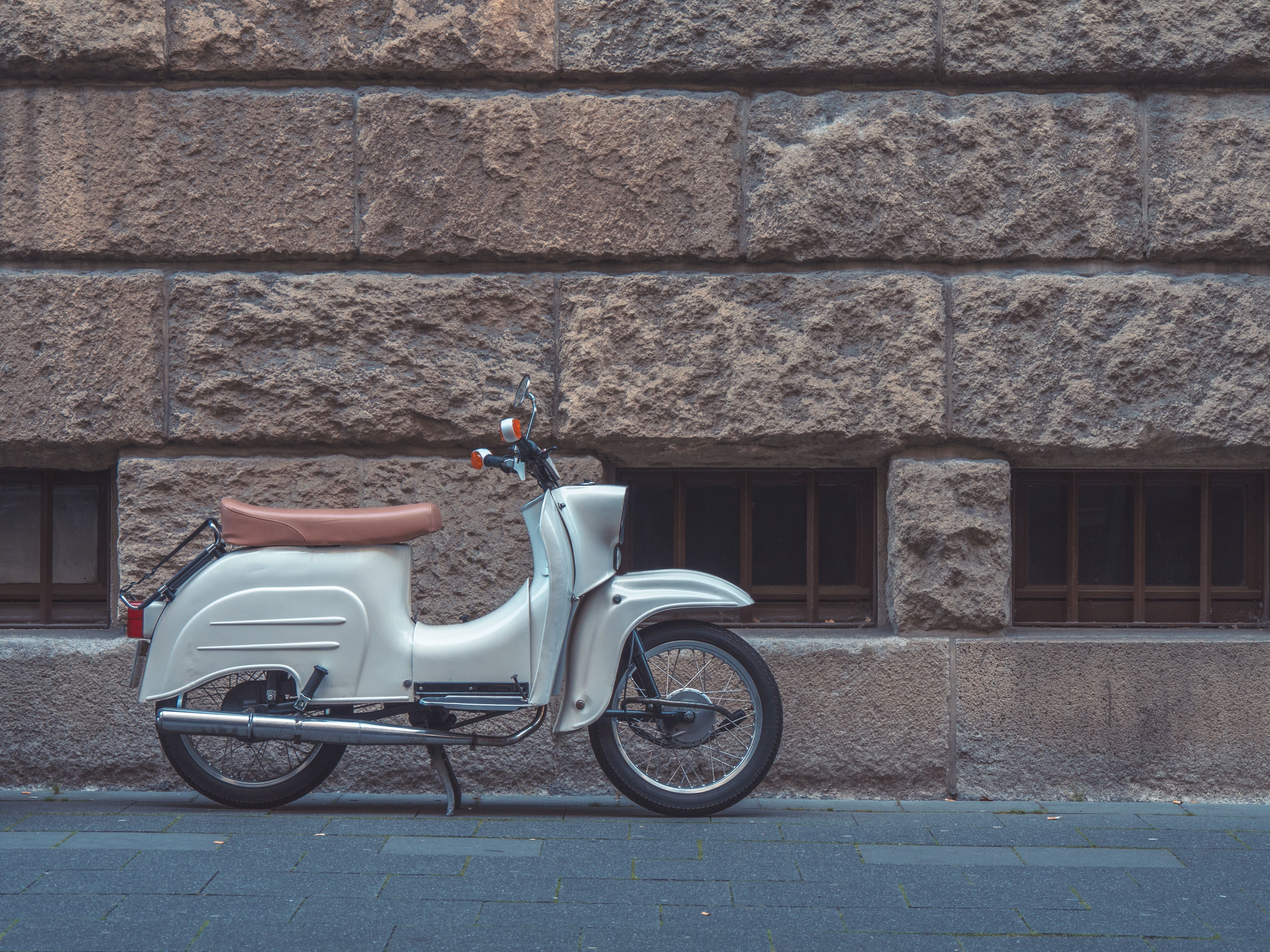 Vintage scooter against stone wall