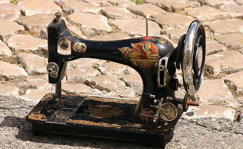 vintage sewing machine on cobblestones