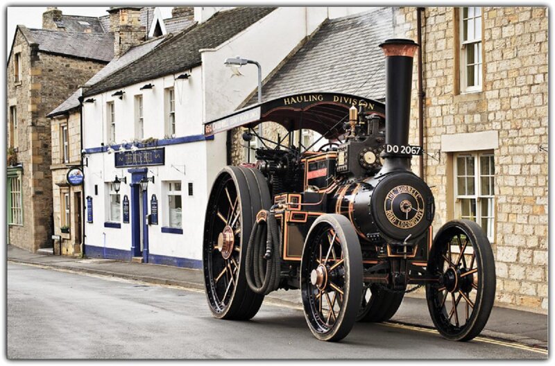 Vintage steam traction engine on street