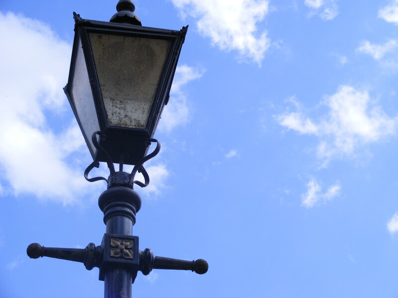 vintage street lamp against blue sky