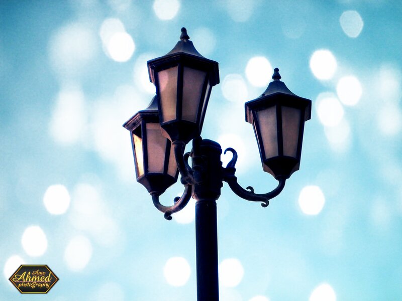 vintage street lamp against bokeh sky
