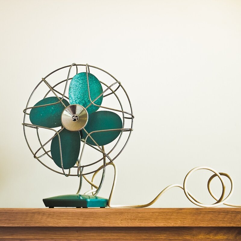 vintage teal fan on wood