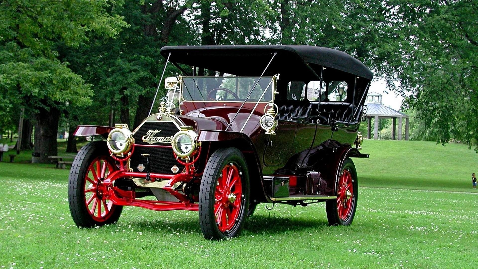 Vintage Thomas automobile on grass
