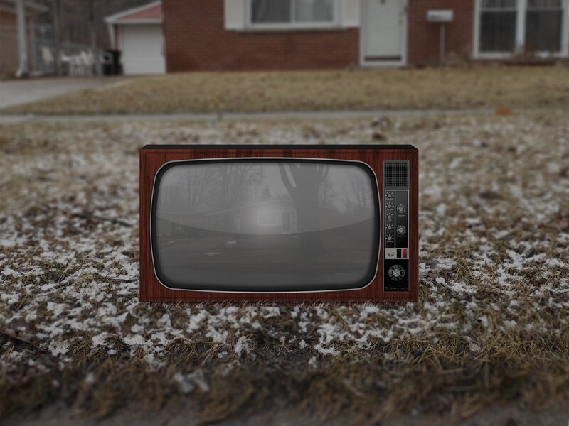 Vintage TV on snowy lawn