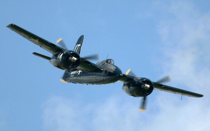 vintage twin-engine aircraft in flight