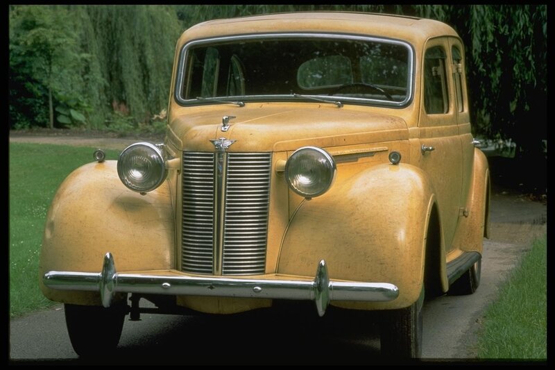 Vintage yellow car in garden