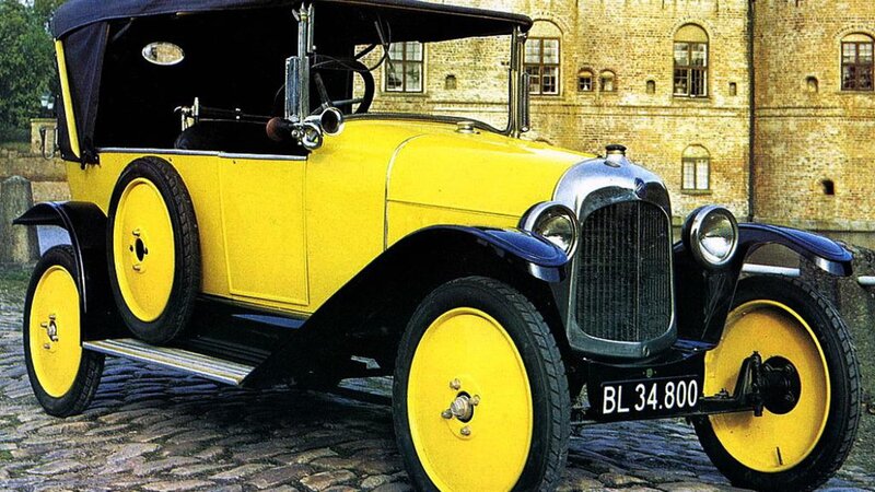 vintage yellow car on cobblestones