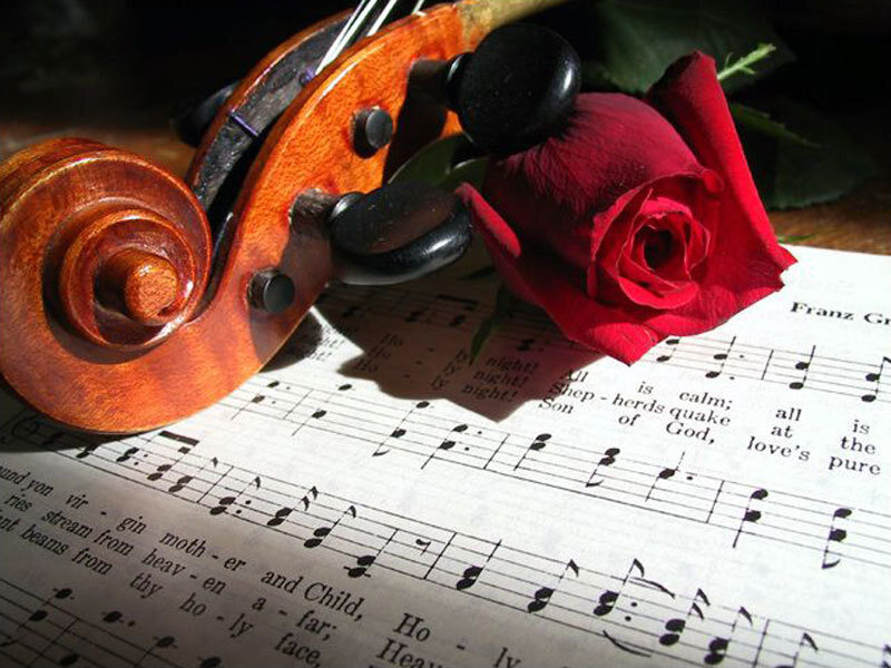 Violin and rose on sheet music