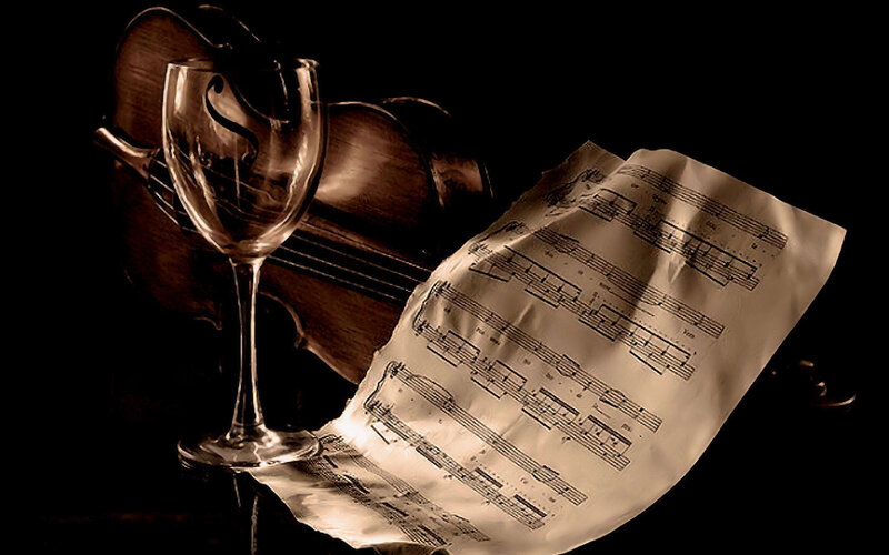 Violin and sheet music with wine glass