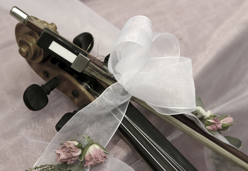 Violin with ribbon and flowers