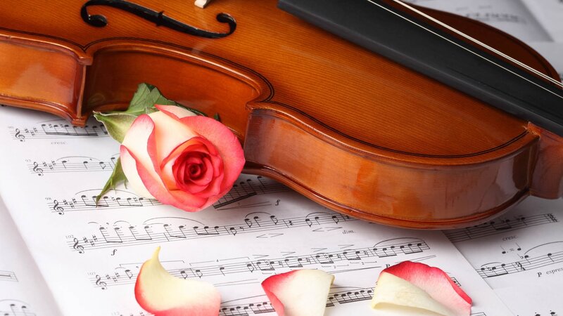 Violin with rose on sheet music