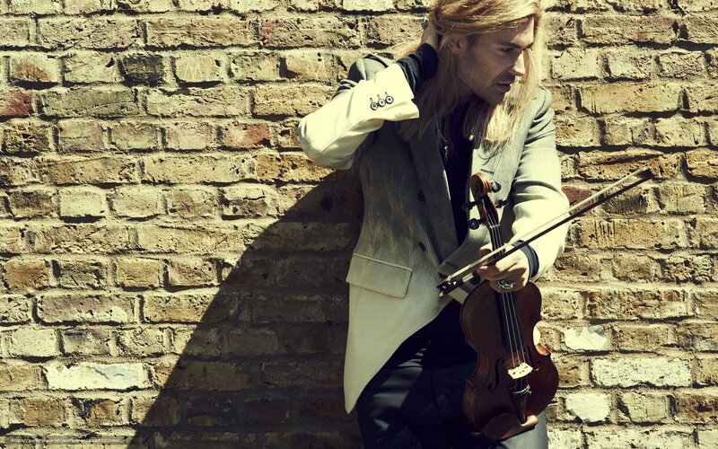 Violinist against brick wall