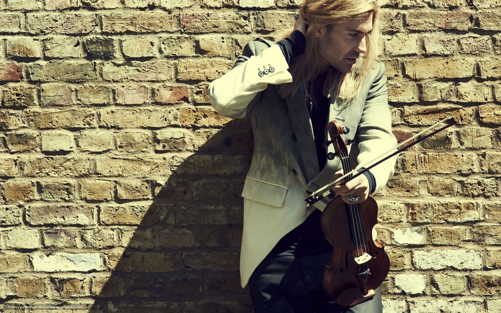 Violinist against brick wall