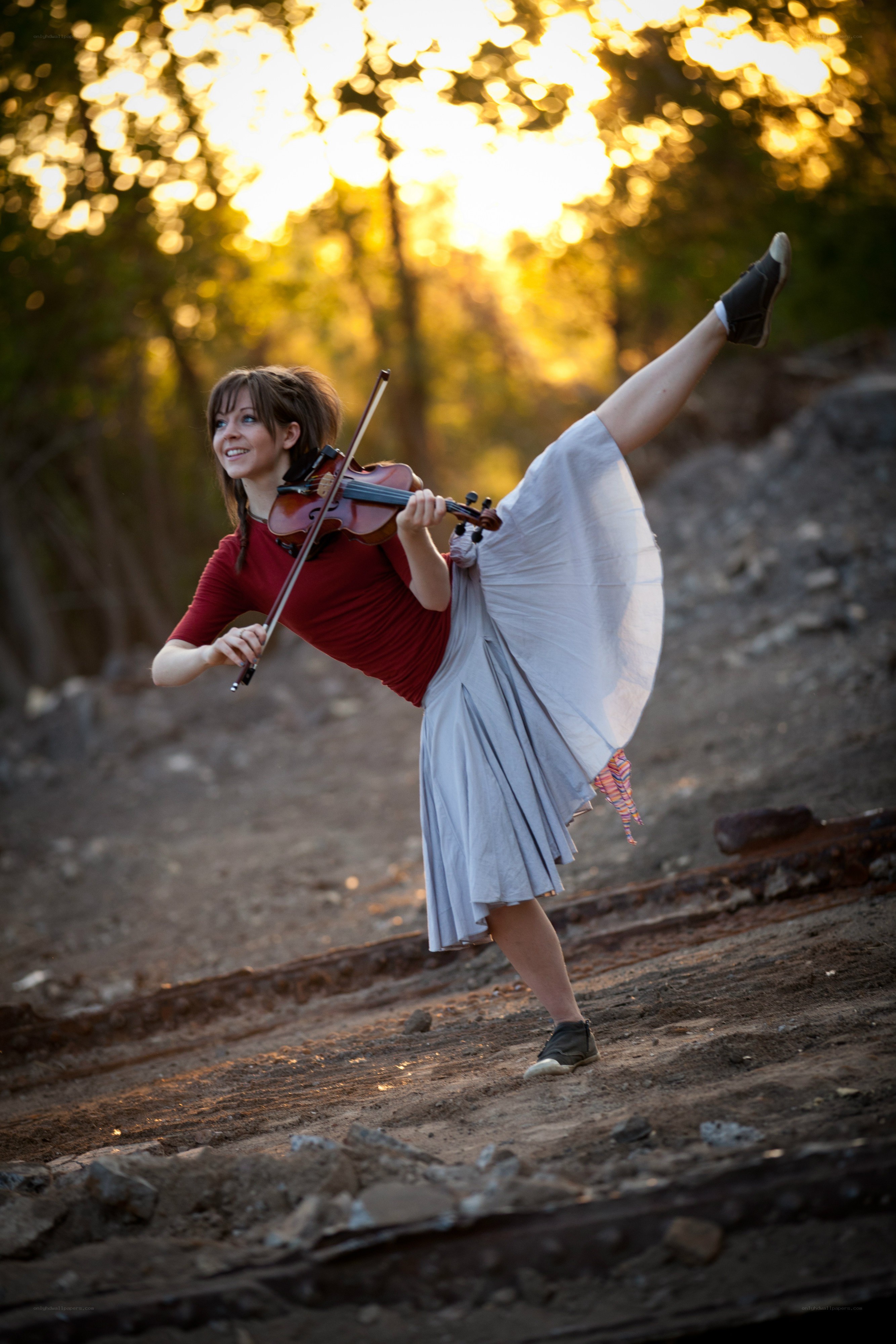 Violinist in motion at sunset