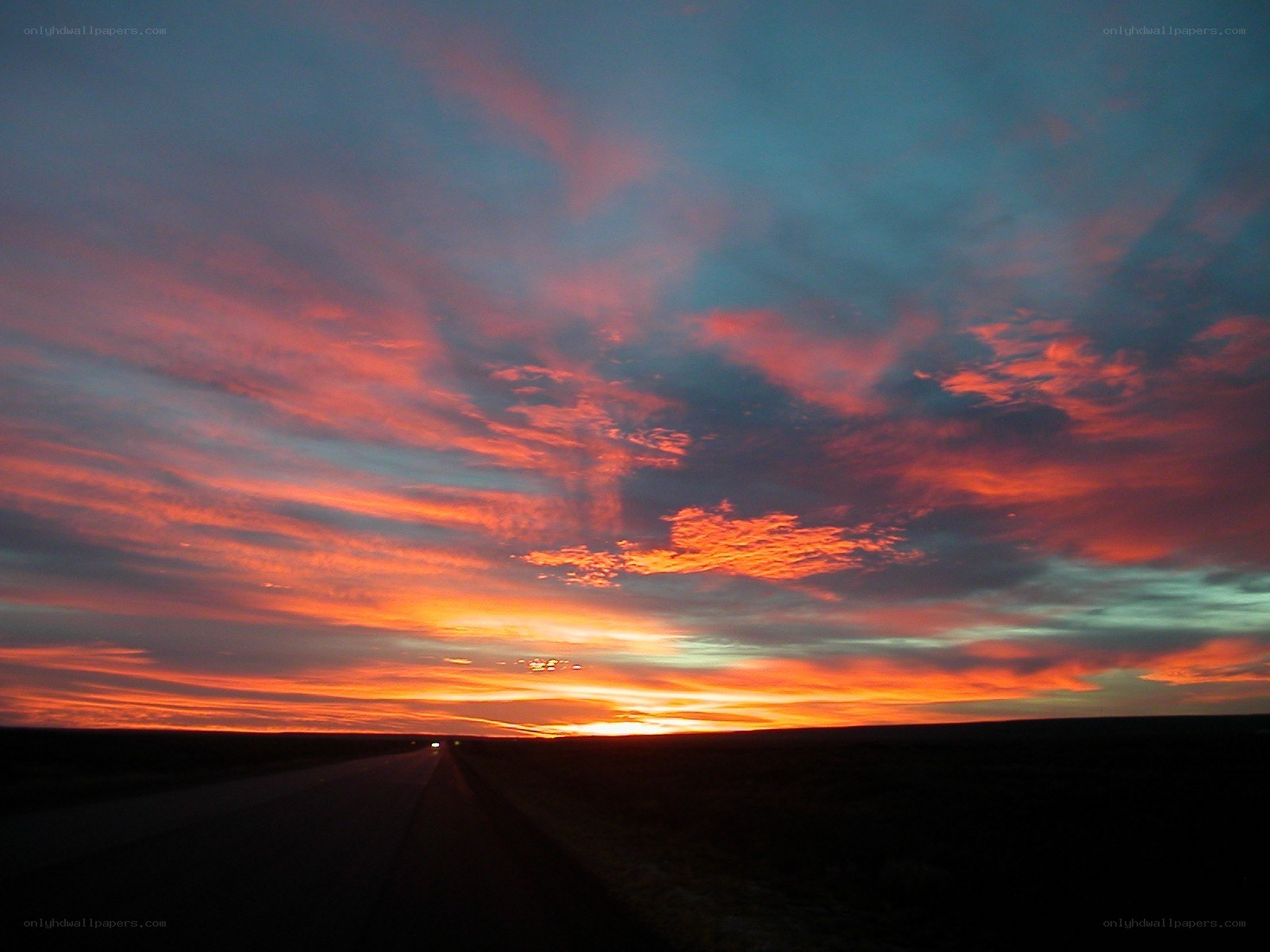 Vivid sunset over a long road