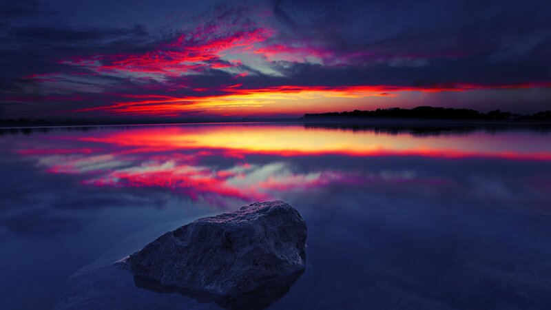 Vivid sunset over calm water