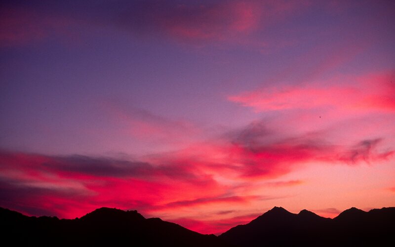 Vivid sunset over mountain silhouettes