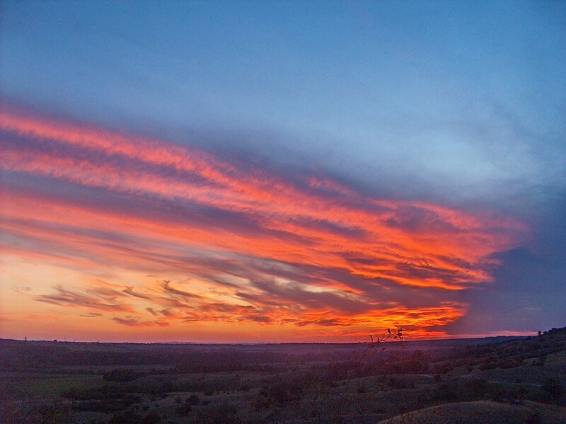 Vivid sunset over rolling hills