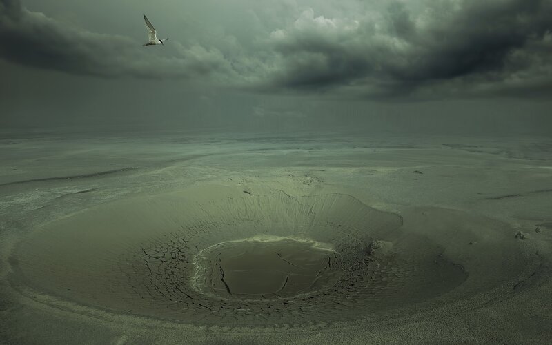 Volcanic crater under stormy sky