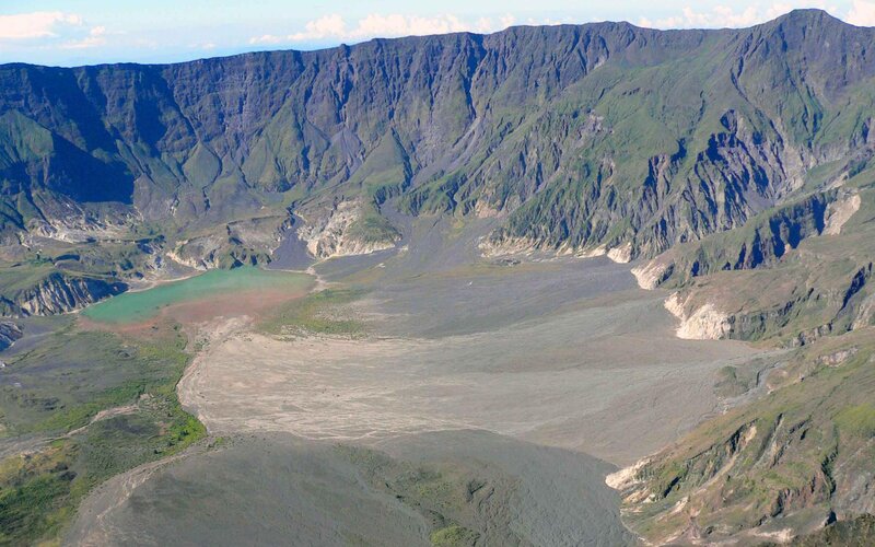 volcanic crater with green lake