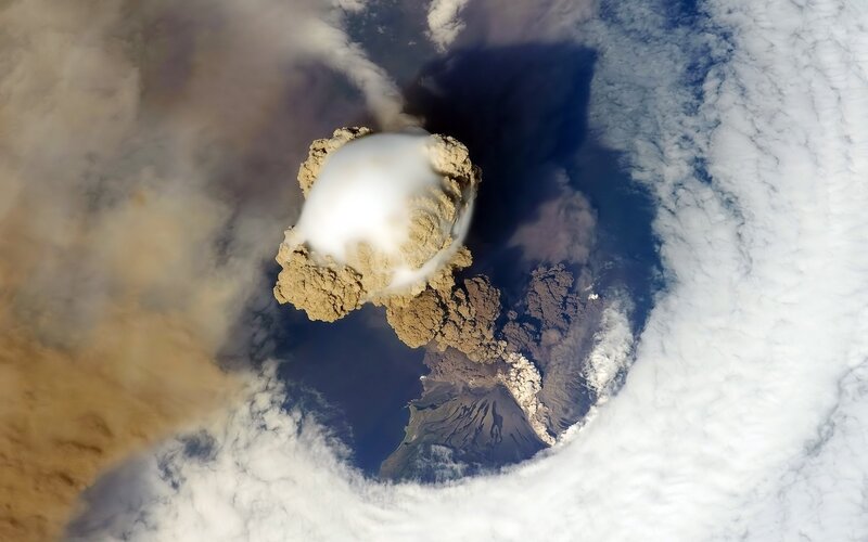 Volcanic Eruption from Space — White, Dramatic, Photograph