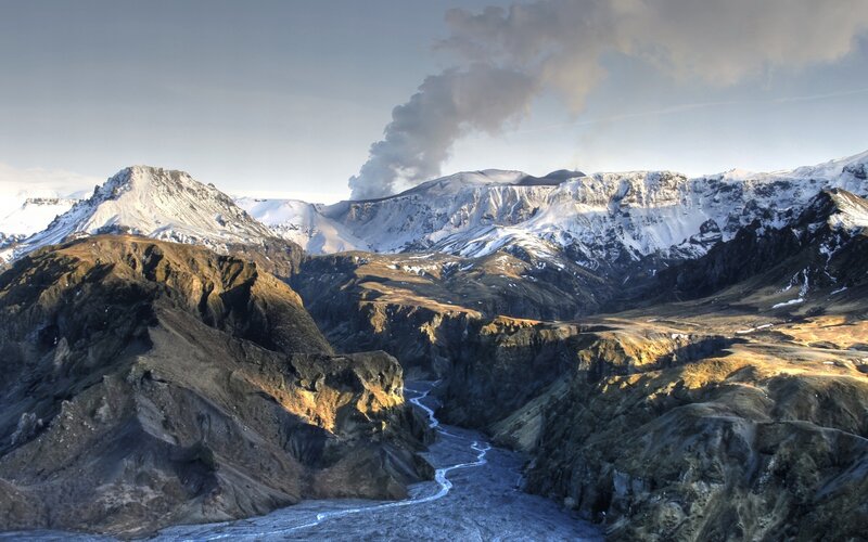 volcanic eruption in snowy mountains