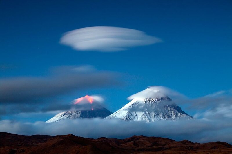 Volcanic eruption with lenticular clouds