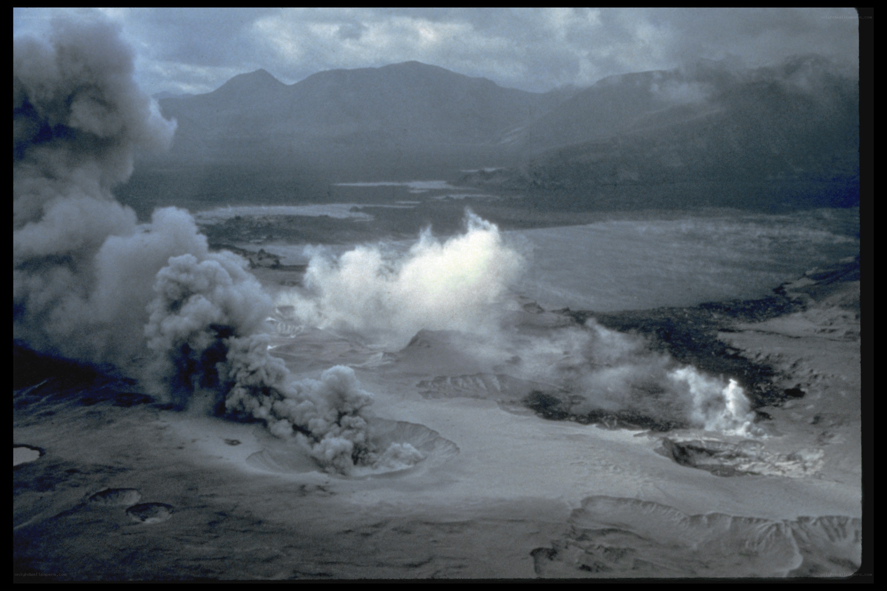 Volcanic eruption with smoke plumes