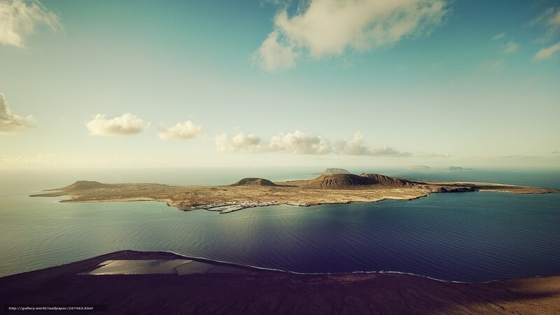 Volcanic Island in Ocean — Blue, Serene, Afternoon, Photograph, Clouds, Mountains